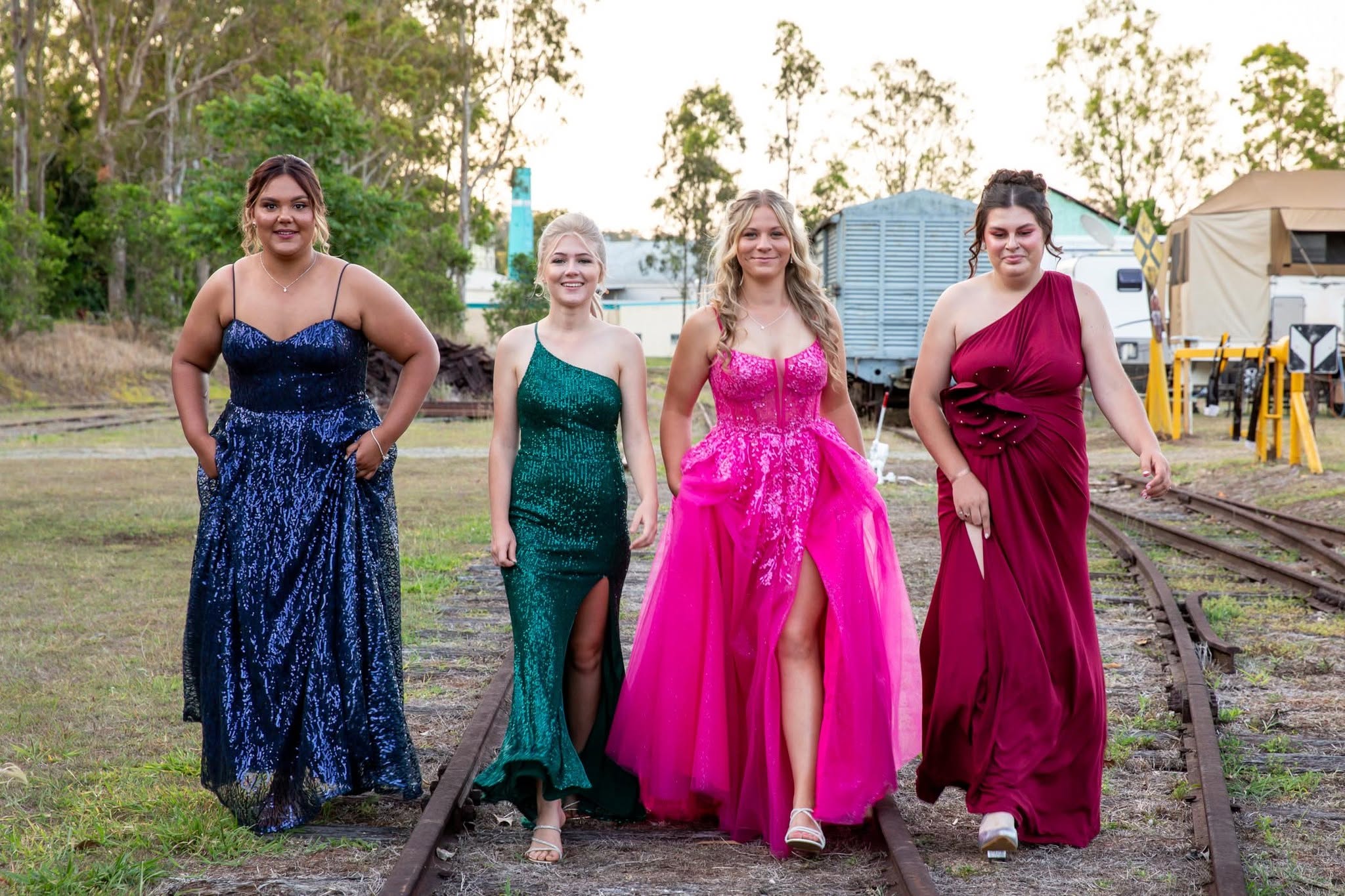 Torimba Festival Queen Entrants in evening gowns walking along the Ravenshoe railway tracks